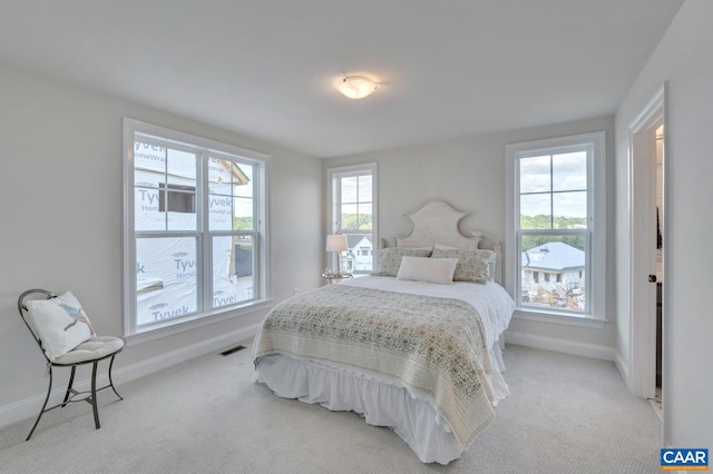 carpeted bedroom with multiple windows