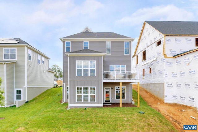 rear view of house featuring a lawn