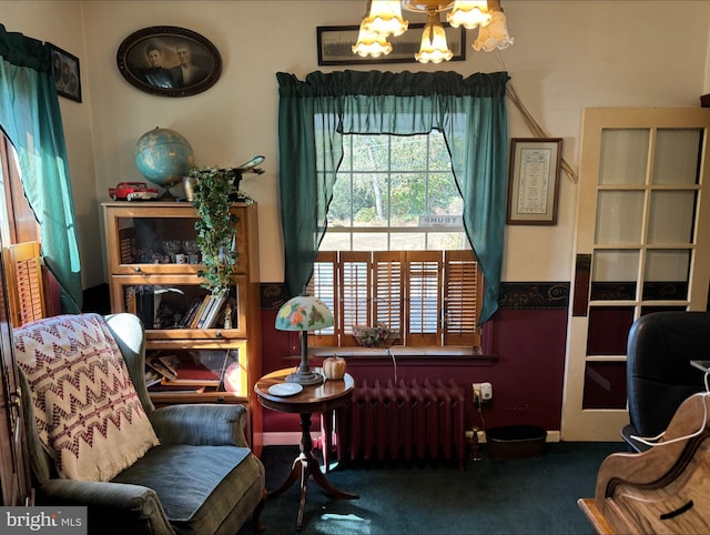 sitting room with dark colored carpet and radiator