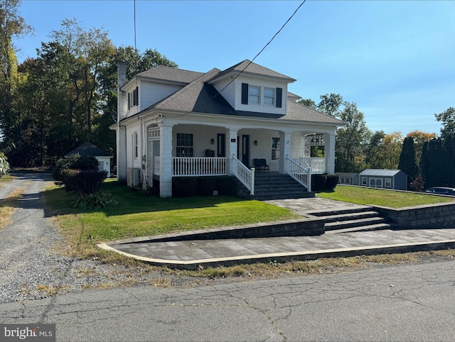 bungalow with central AC, a front yard, and a porch