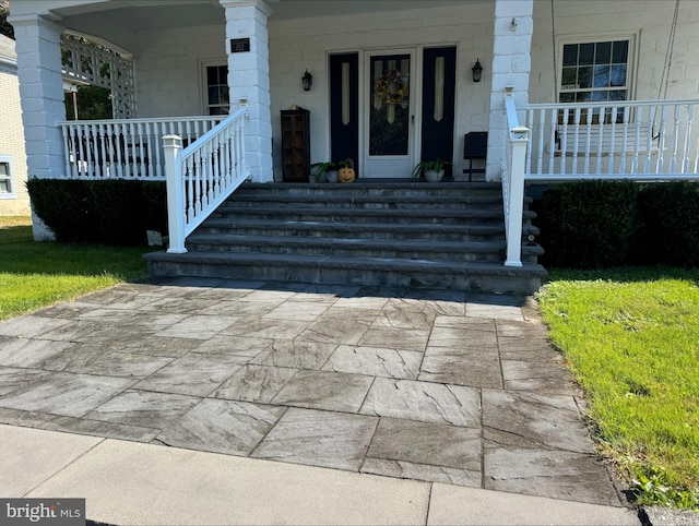 property entrance featuring covered porch