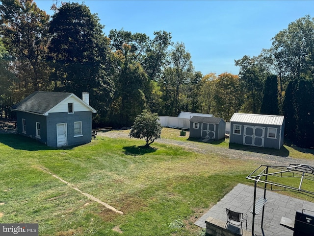 view of yard featuring a patio and a shed