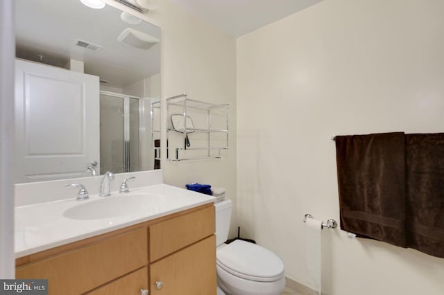 bathroom featuring an enclosed shower, vanity, and toilet