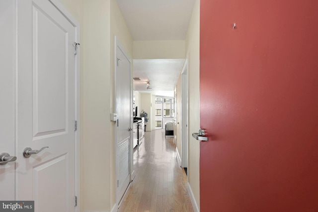 hall with light hardwood / wood-style floors