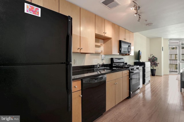 kitchen featuring light wood-type flooring, black appliances, sink, and light brown cabinets