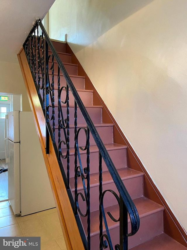 staircase featuring tile patterned floors