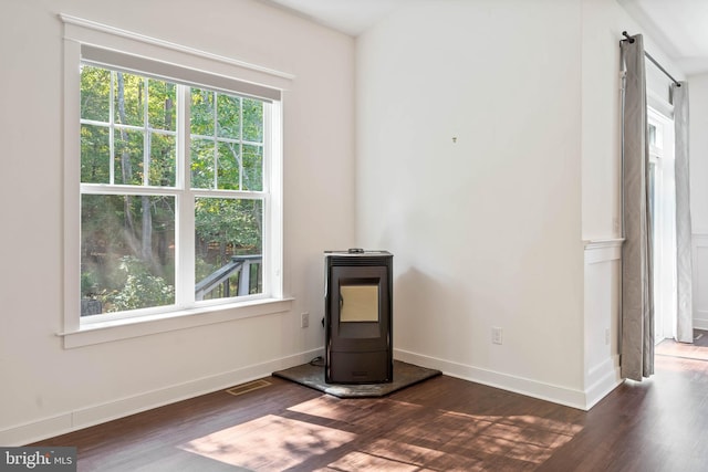 interior space with plenty of natural light and dark hardwood / wood-style floors