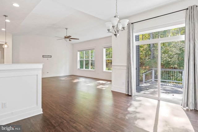 interior space featuring ceiling fan with notable chandelier and dark hardwood / wood-style flooring