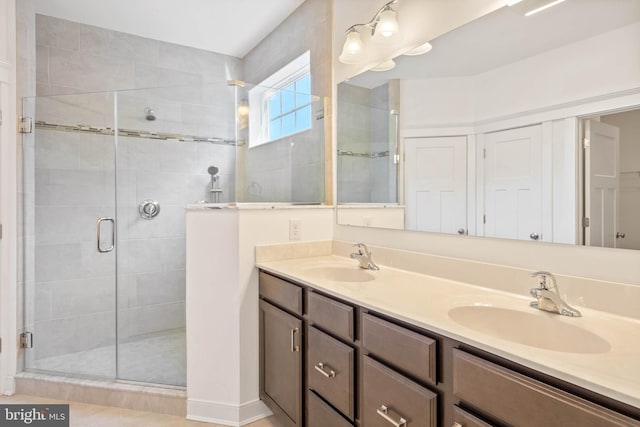 bathroom featuring walk in shower, tile patterned floors, and vanity