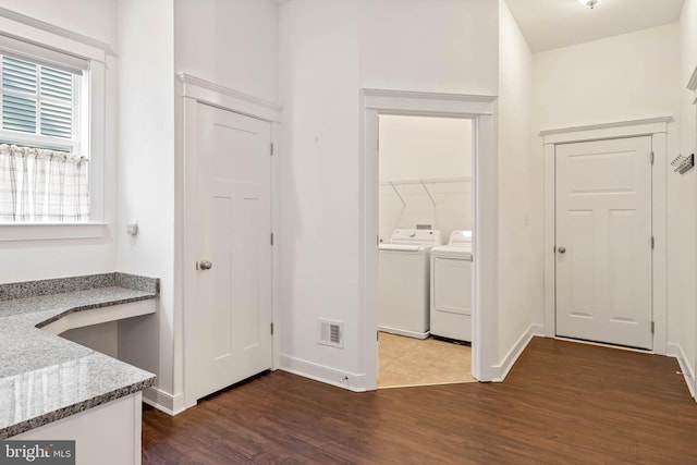 interior space with separate washer and dryer and dark wood-type flooring