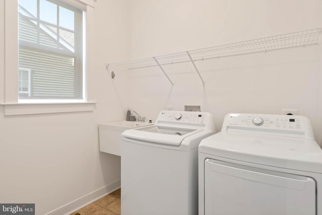 clothes washing area featuring separate washer and dryer