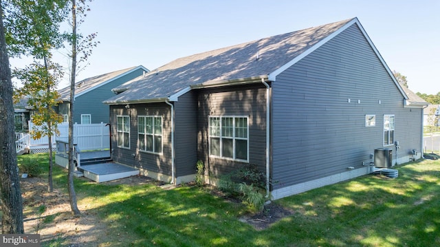 exterior space with a yard, central AC, and a deck