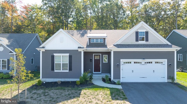 view of front of property with a garage and a front lawn