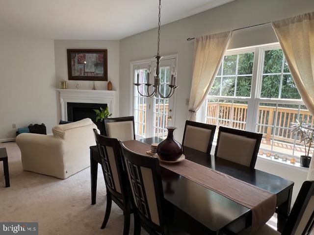 dining area with a chandelier and carpet