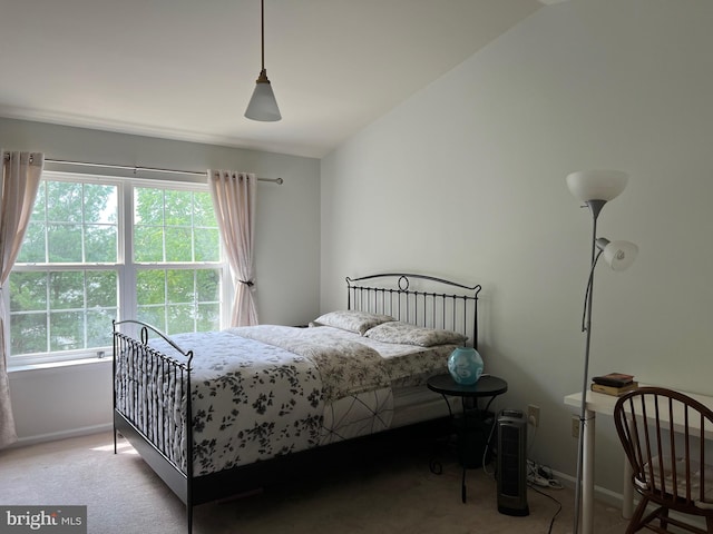 bedroom featuring vaulted ceiling and light carpet