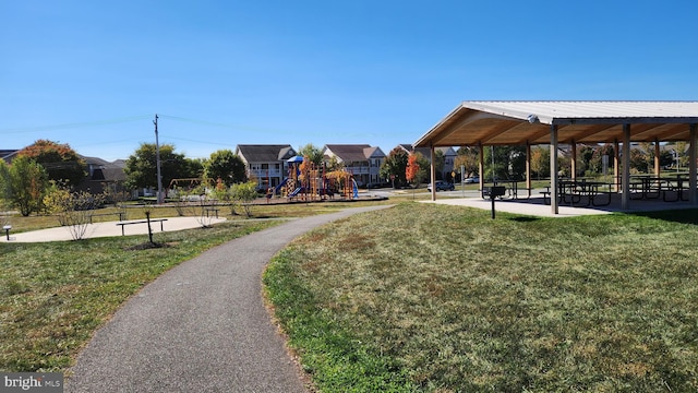 view of property's community featuring a lawn and a playground