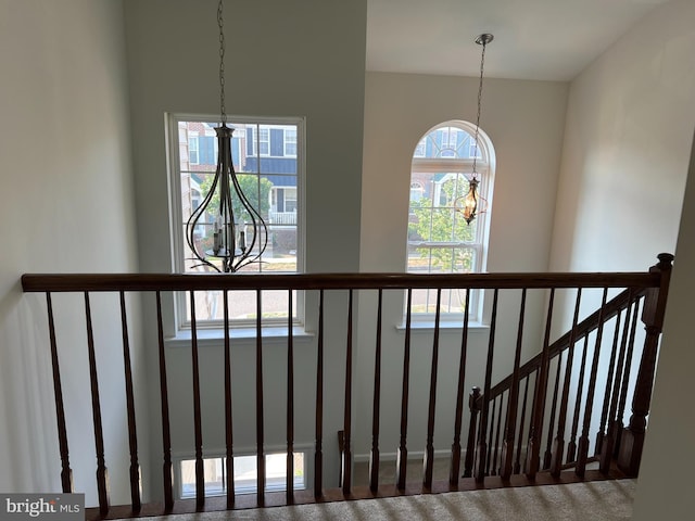 interior details with carpet and a chandelier