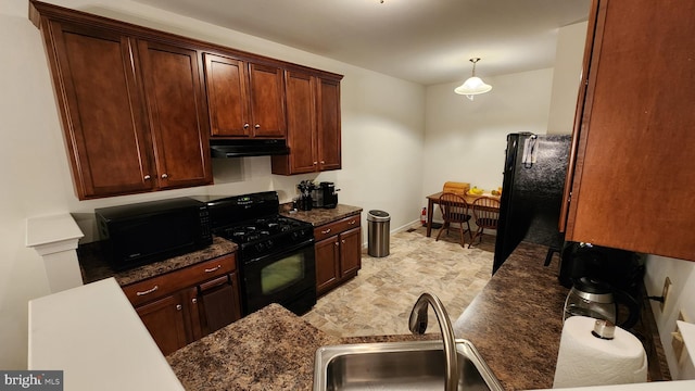 kitchen featuring black appliances, sink, and hanging light fixtures