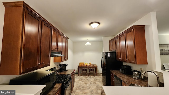 kitchen featuring hanging light fixtures, black appliances, and sink