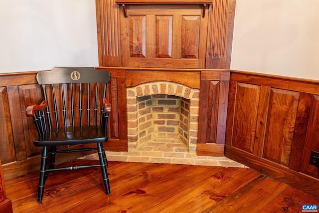 room details featuring a fireplace and hardwood / wood-style flooring