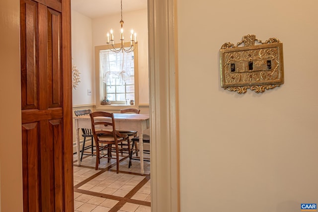 interior space with light tile patterned floors and a chandelier