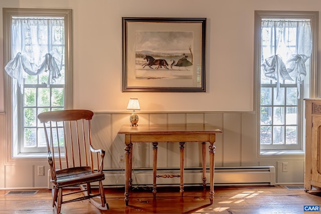 sitting room featuring plenty of natural light and hardwood / wood-style floors