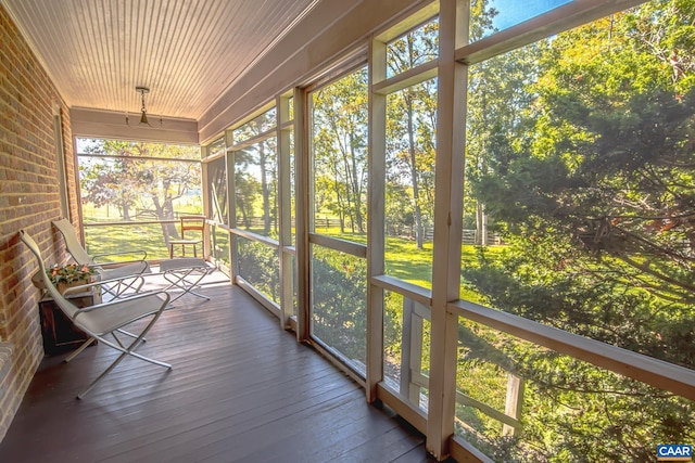 unfurnished sunroom with wooden ceiling