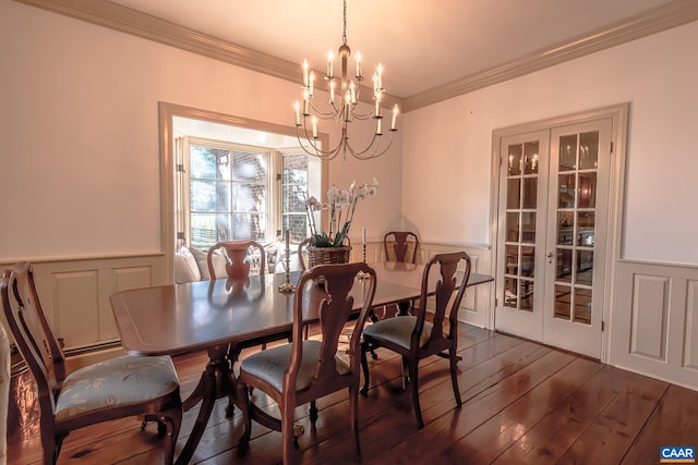 dining space featuring dark hardwood / wood-style floors, ornamental molding, and a chandelier