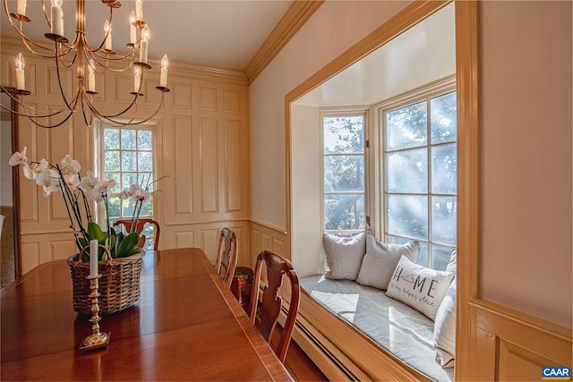 dining room featuring ornamental molding, a healthy amount of sunlight, and an inviting chandelier