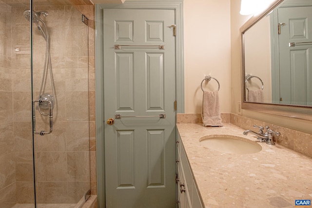 bathroom featuring walk in shower and vanity