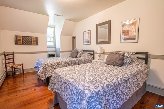 bedroom featuring hardwood / wood-style flooring and lofted ceiling