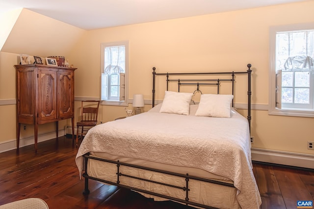 bedroom featuring dark wood-type flooring and baseboard heating