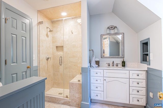 bathroom featuring lofted ceiling, a shower with door, tile patterned flooring, and vanity