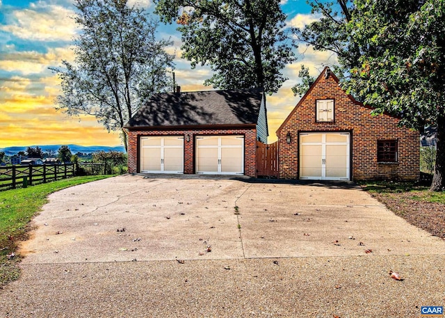 view of garage at dusk