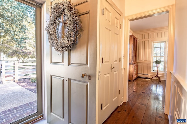 interior space featuring baseboard heating and dark wood-type flooring