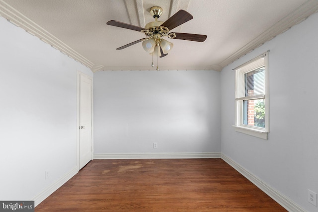 spare room with ornamental molding, a textured ceiling, dark hardwood / wood-style floors, and ceiling fan