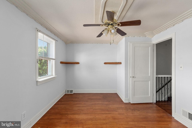 unfurnished room with ornamental molding, a textured ceiling, hardwood / wood-style flooring, and ceiling fan