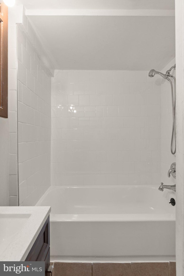 bathroom with vanity and tiled shower / bath combo