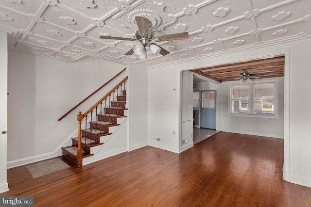 unfurnished living room featuring ceiling fan, ornamental molding, and hardwood / wood-style floors