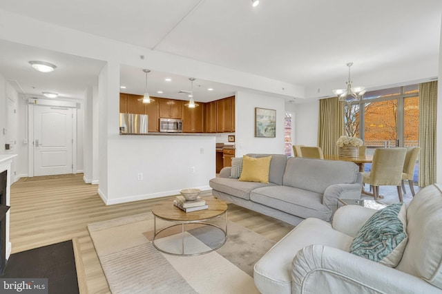 living room featuring light hardwood / wood-style flooring and a chandelier