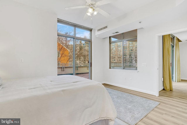 bedroom with ceiling fan, light hardwood / wood-style floors, and access to exterior