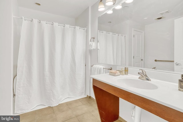 bathroom with tile patterned floors and vanity