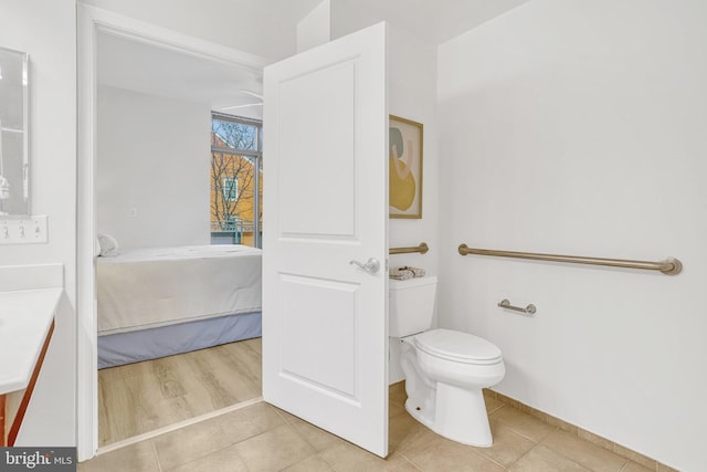 bathroom with hardwood / wood-style flooring and toilet