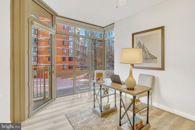 sitting room with floor to ceiling windows, light hardwood / wood-style flooring, and plenty of natural light