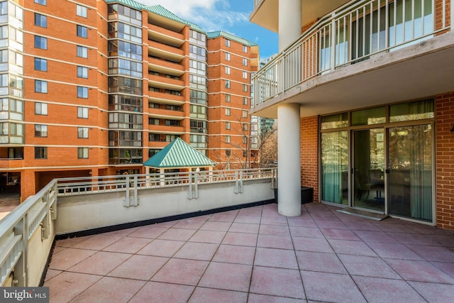 view of patio featuring a balcony