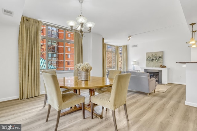 dining room featuring light hardwood / wood-style flooring and a notable chandelier