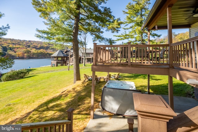 view of yard with a deck with water view