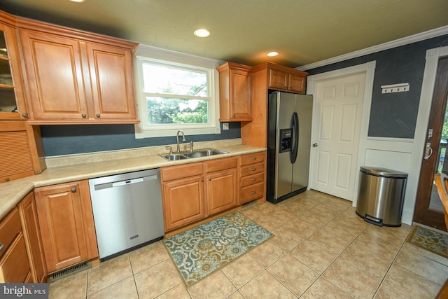 kitchen with sink, crown molding, stainless steel appliances, and light tile patterned flooring