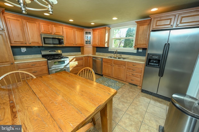 kitchen featuring appliances with stainless steel finishes, sink, and light tile patterned floors