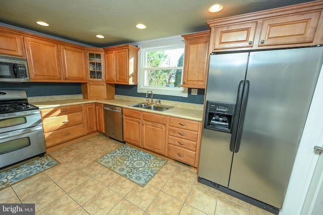 kitchen featuring sink, light tile patterned flooring, and appliances with stainless steel finishes